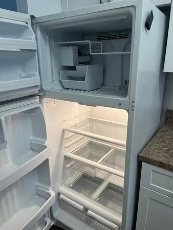 a view of a storage and utility room with washer dryer