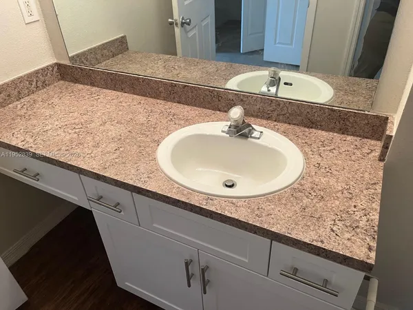 a bathroom with a sink and vanity