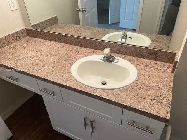 a bathroom with a sink and vanity