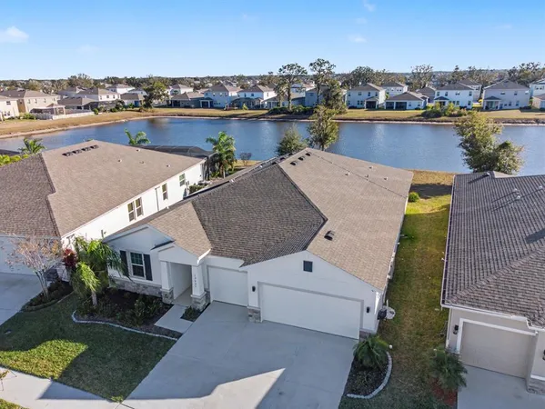 an aerial view of a house with a lake view