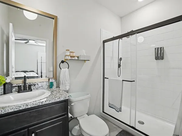 a bedroom with a bed window and a dresser