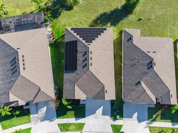 an aerial view of a house with a garden and swimming pool