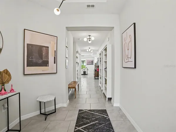 a living room with furniture and a book shelf