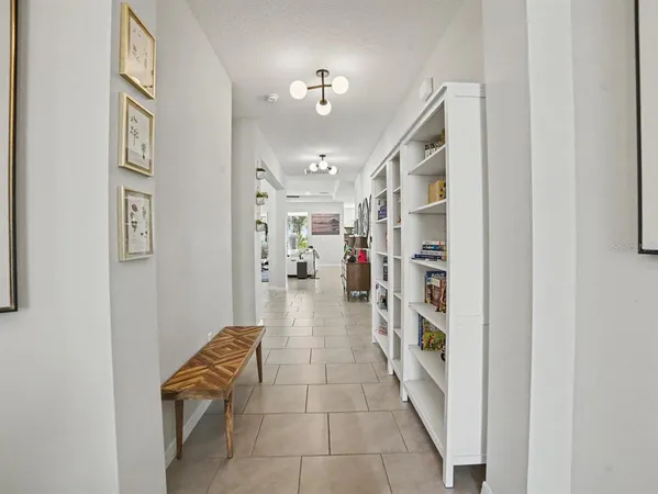 a living room with furniture a clock and a large window