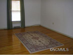 282 Phillipsville Loop Canton, NC 28716 - Photo 6 of 19 an empty room with wooden floor