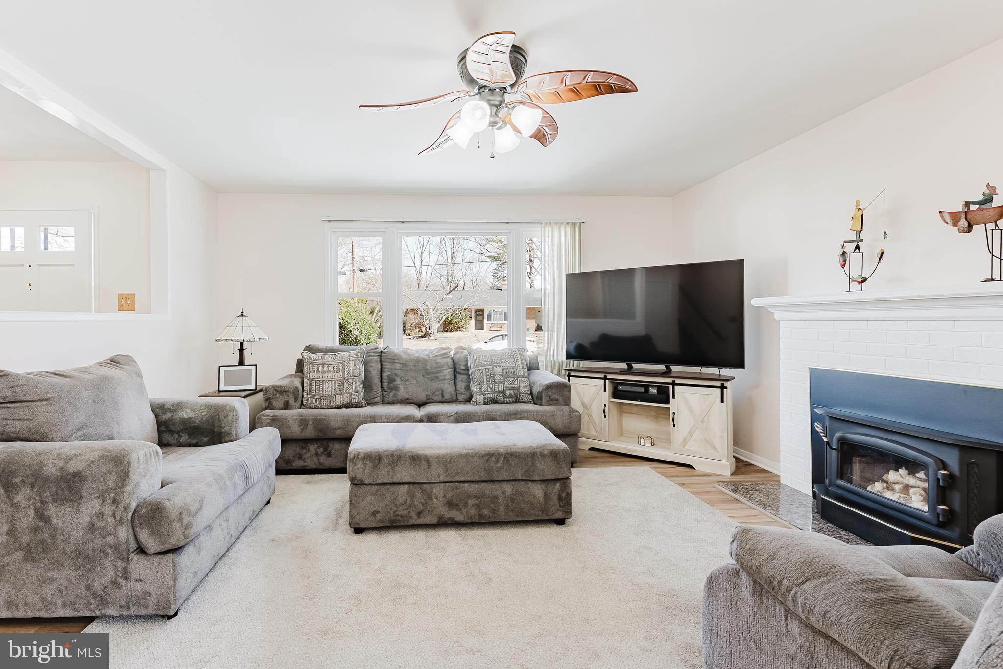 5937 Atteentee Road Springfield, VA 22150 - Photo 15 of 44 a living room with furniture a flat screen tv and a fireplace