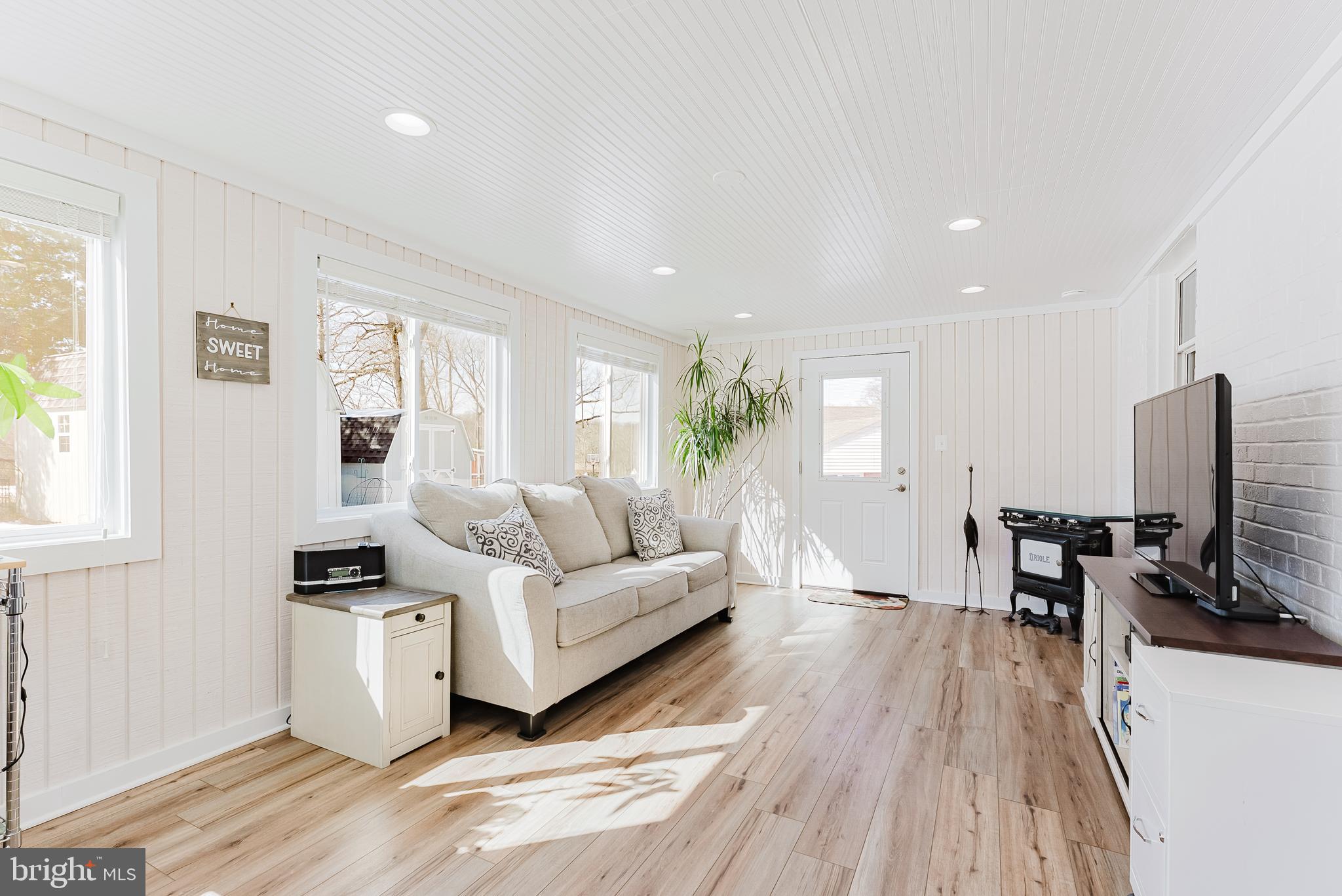 5937 Atteentee Road Springfield, VA 22150 - Photo 16 of 44 a living room with furniture and a flat screen tv