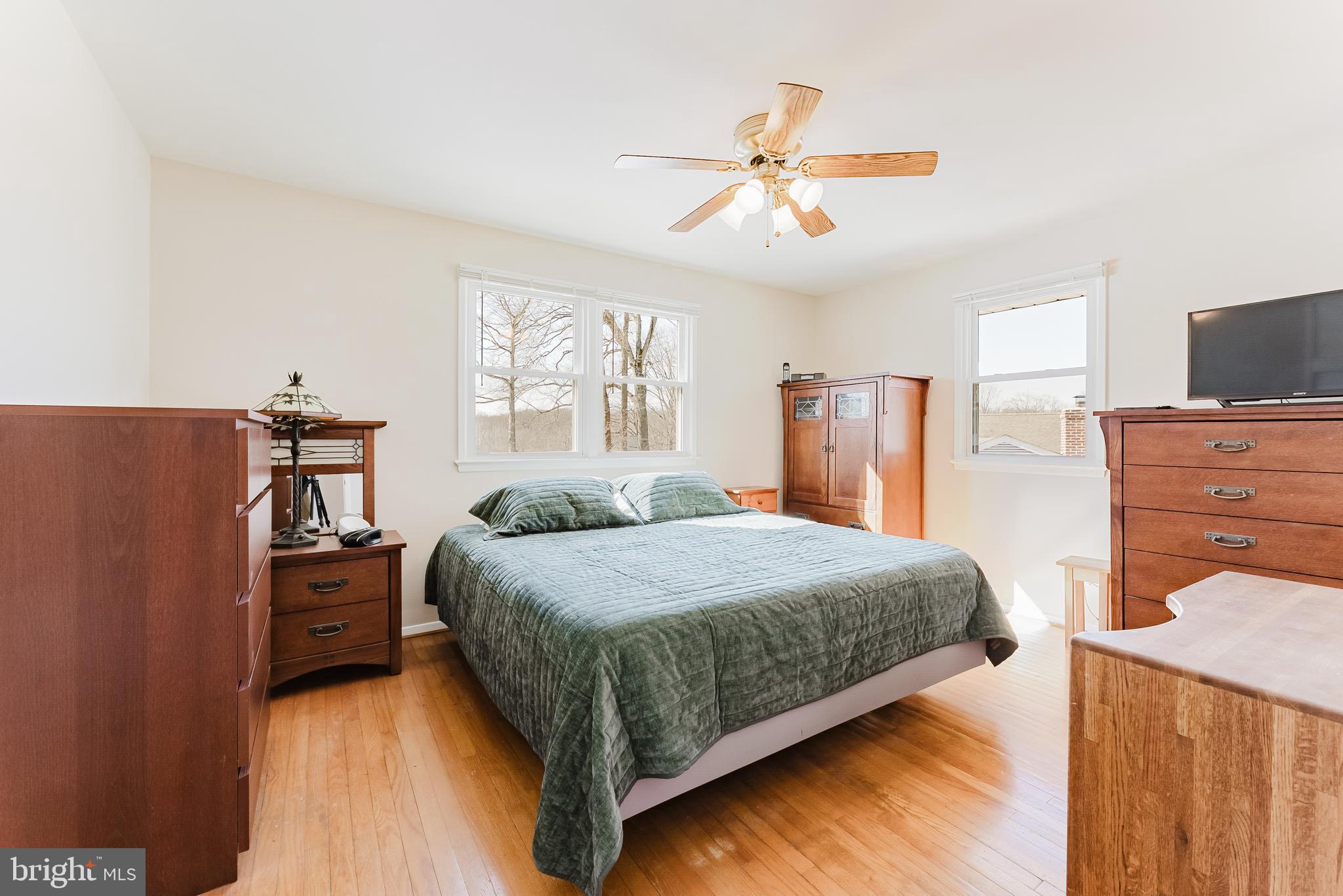 5937 Atteentee Road Springfield, VA 22150 - Photo 17 of 44 a bedroom with a bed and a flat tv screen on dresser