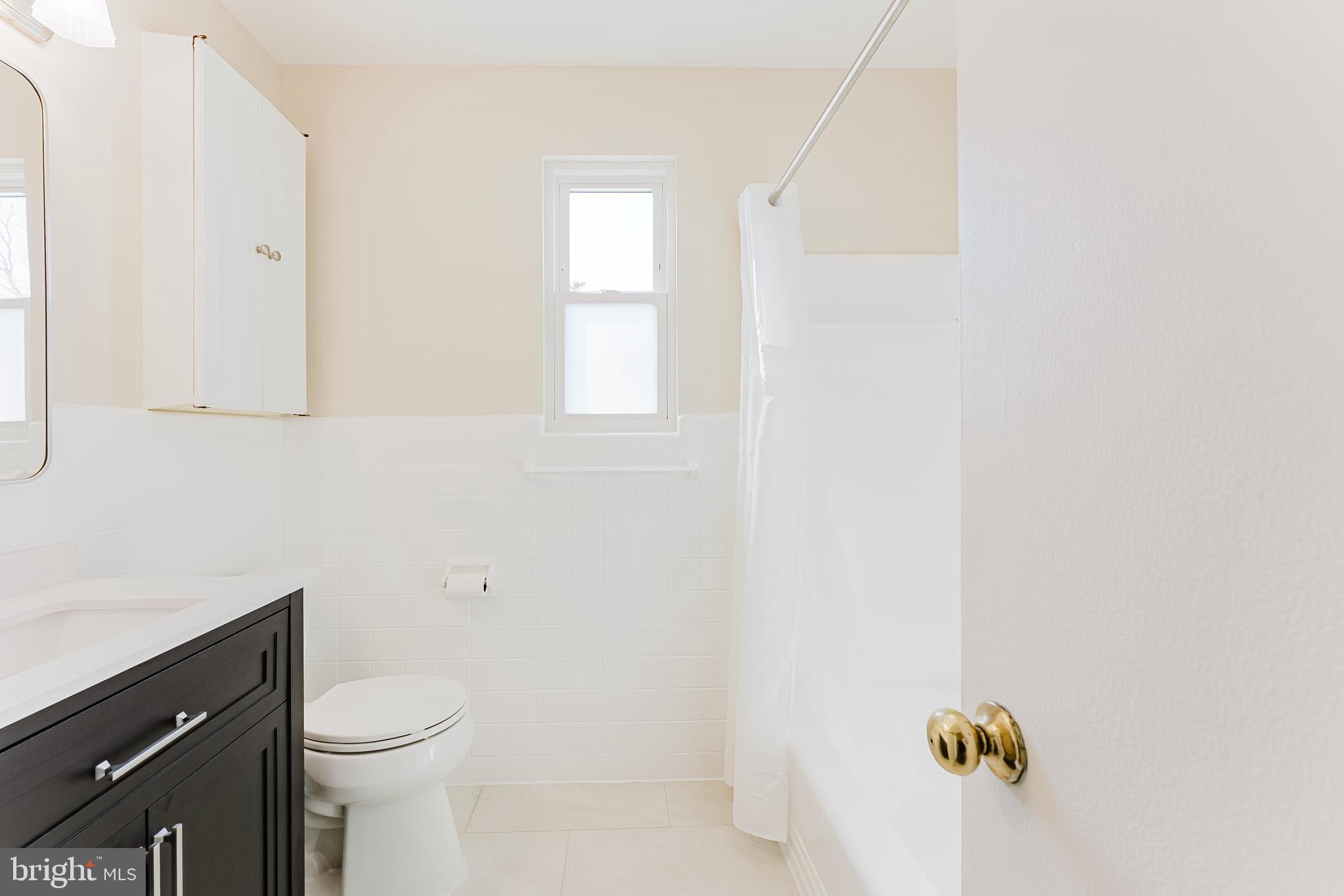 5937 Atteentee Road Springfield, VA 22150 - Photo 19 of 44 a bathroom with a sink a toilet and window