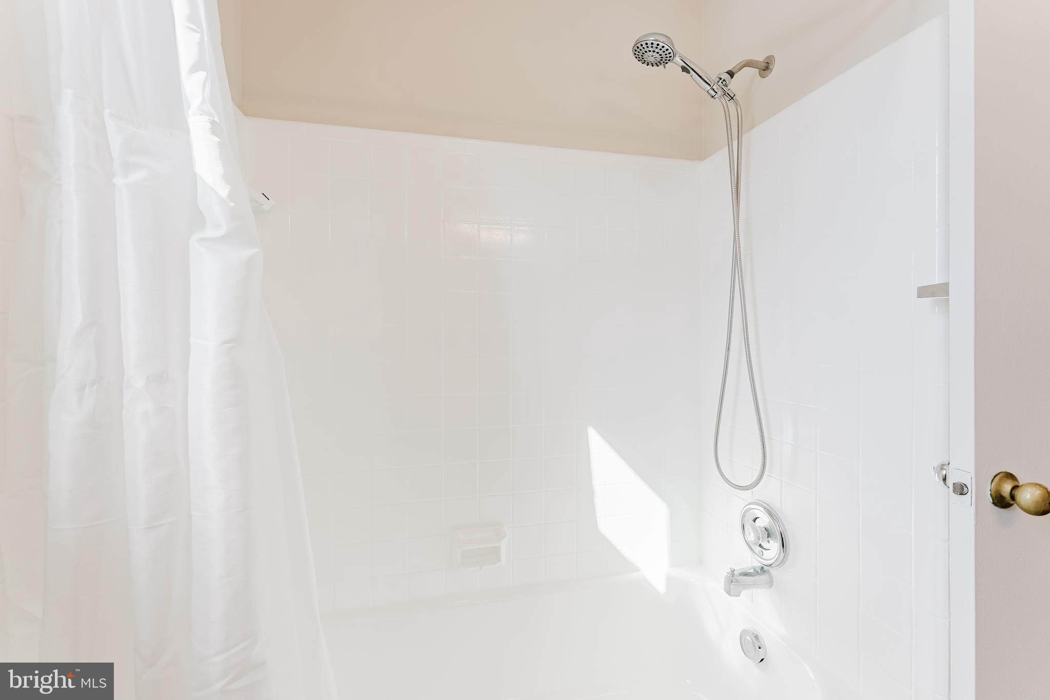 5937 Atteentee Road Springfield, VA 22150 - Photo 20 of 44 a bathroom with a shower curtain