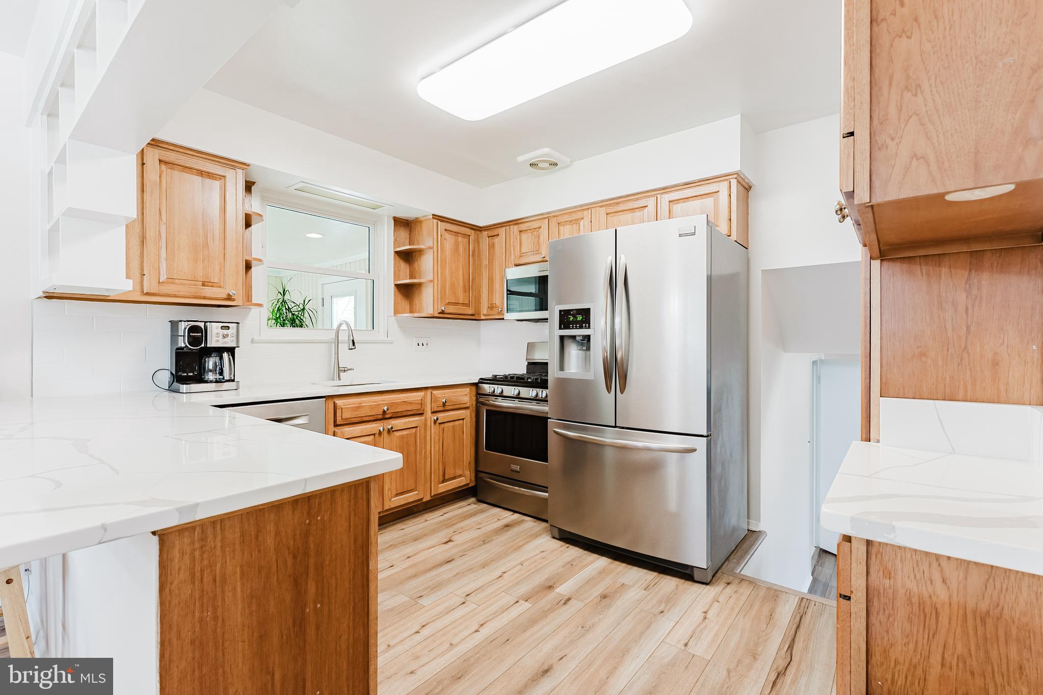 5937 Atteentee Road Springfield, VA 22150 - Photo 6 of 44 a kitchen with stainless steel appliances a refrigerator sink and microwave