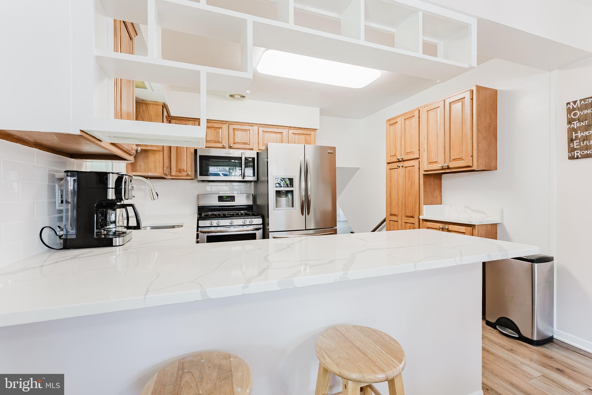5937 Atteentee Road Springfield, VA 22150 - Photo 7 of 44 a kitchen with stainless steel appliances a refrigerator and a stove top oven