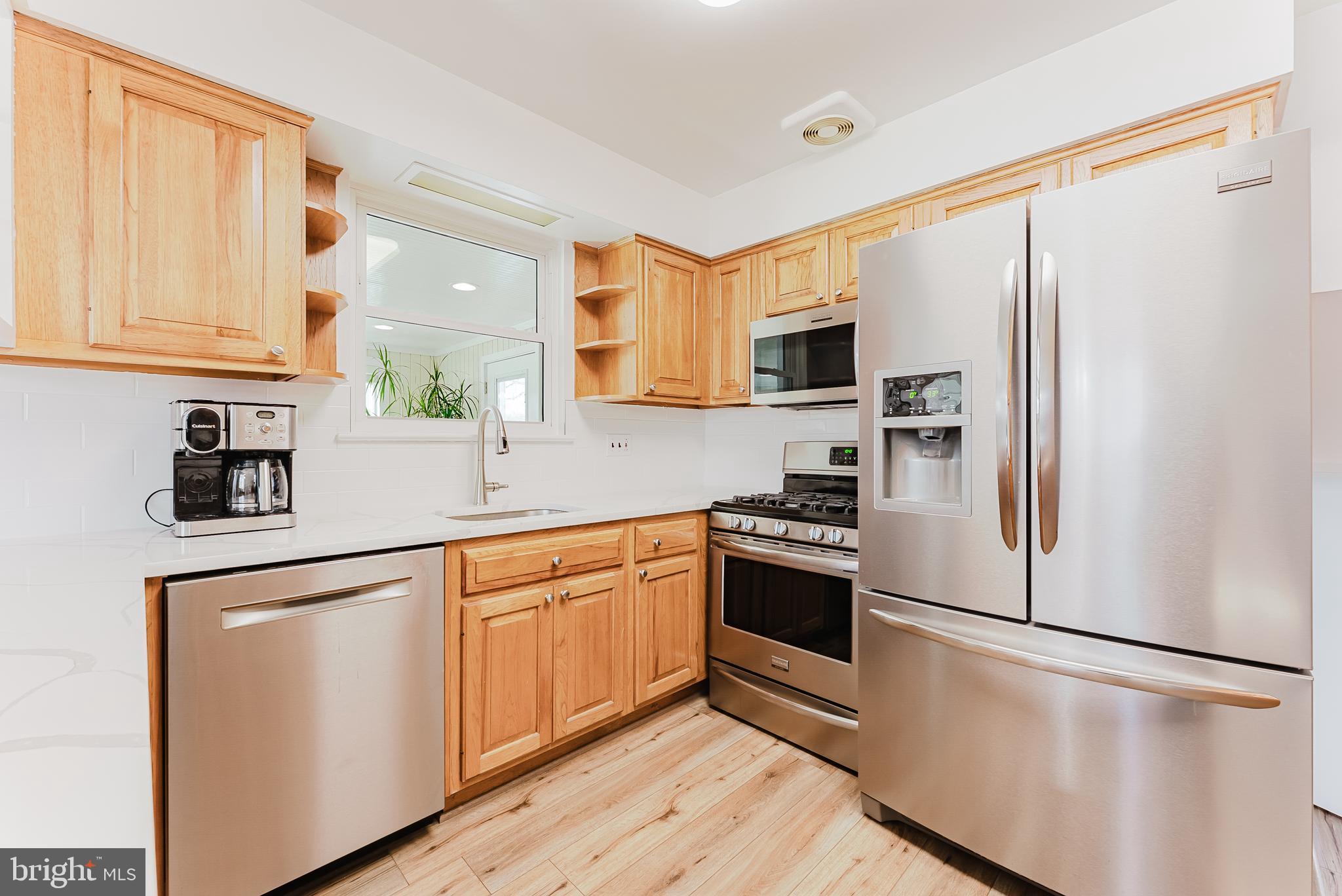 5937 Atteentee Road Springfield, VA 22150 - Photo 8 of 44 a kitchen with stainless steel appliances a refrigerator sink and microwave