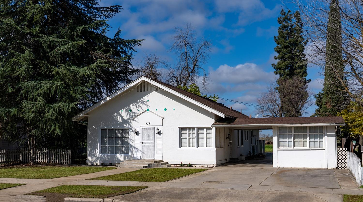 537 South Reed Avenue Reedley, CA 93654 - Photo 36 of 57 a front view of a house with a yard and garage