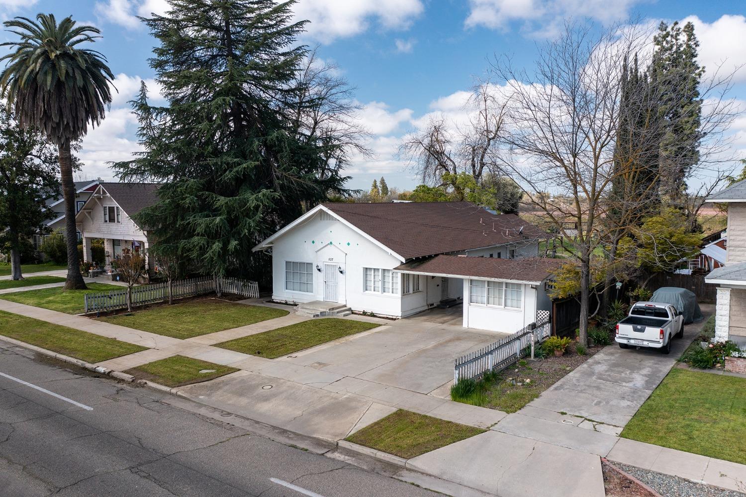 537 South Reed Avenue Reedley, CA 93654 - Photo 54 of 57 a front view of a house with a garden and trees