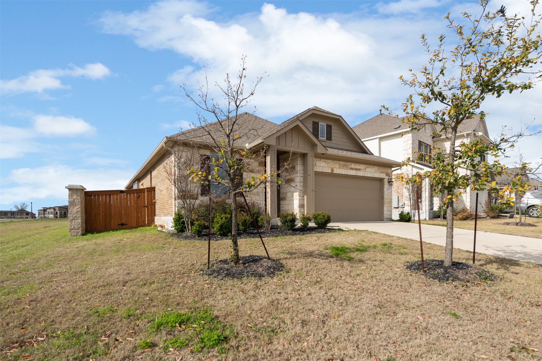18304 Blush Rose Road Pflugerville, TX 78660 - Photo 1 of 16 Textured stone veneer accents the exterior facade of this single-story suburban home.