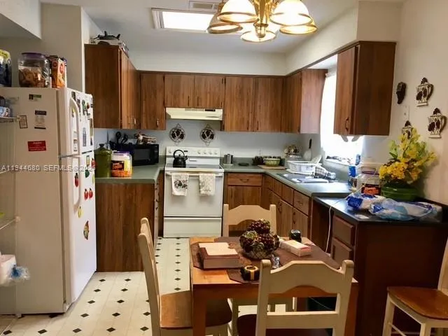 a kitchen with a sink stove and refrigerator