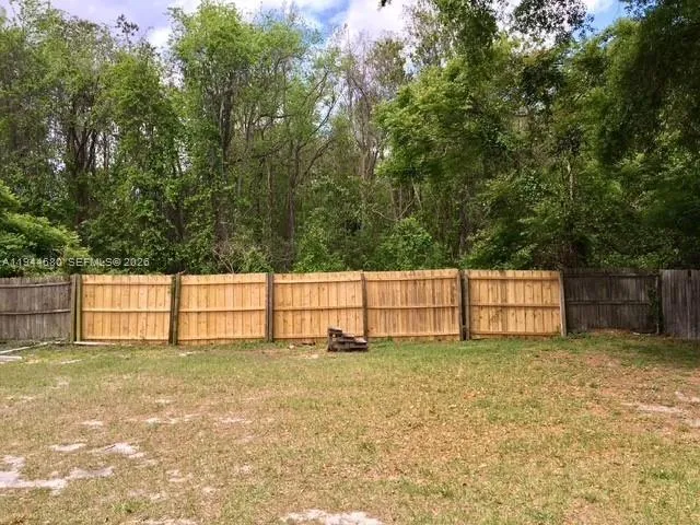 a view of yard with large trees
