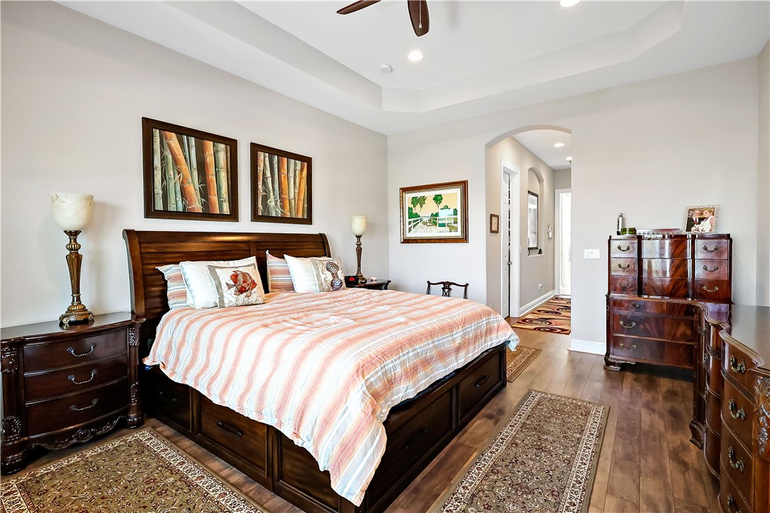 607 Yearling Trail Sebastian, FL 32958 - Photo 15 of 33 a bedroom with a bed and wooden floor