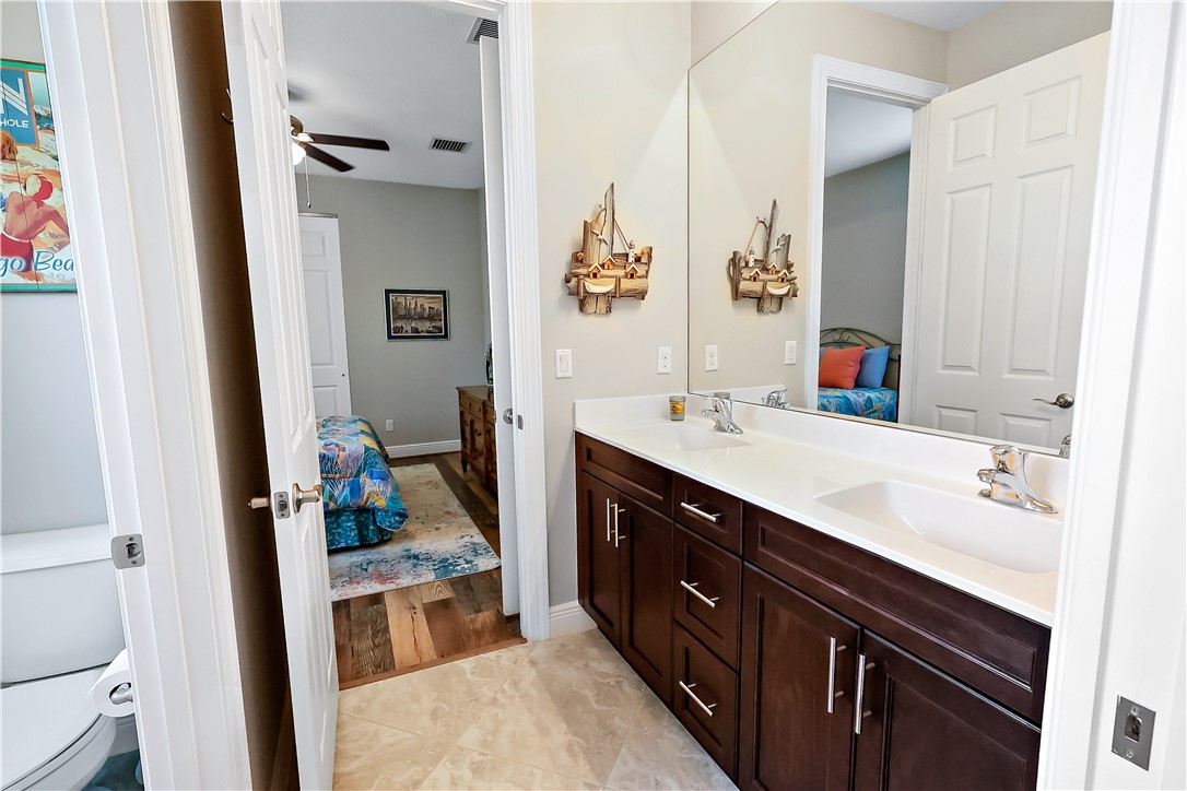607 Yearling Trail Sebastian, FL 32958 - Photo 17 of 33 a bathroom with a sink a vanity and a mirror