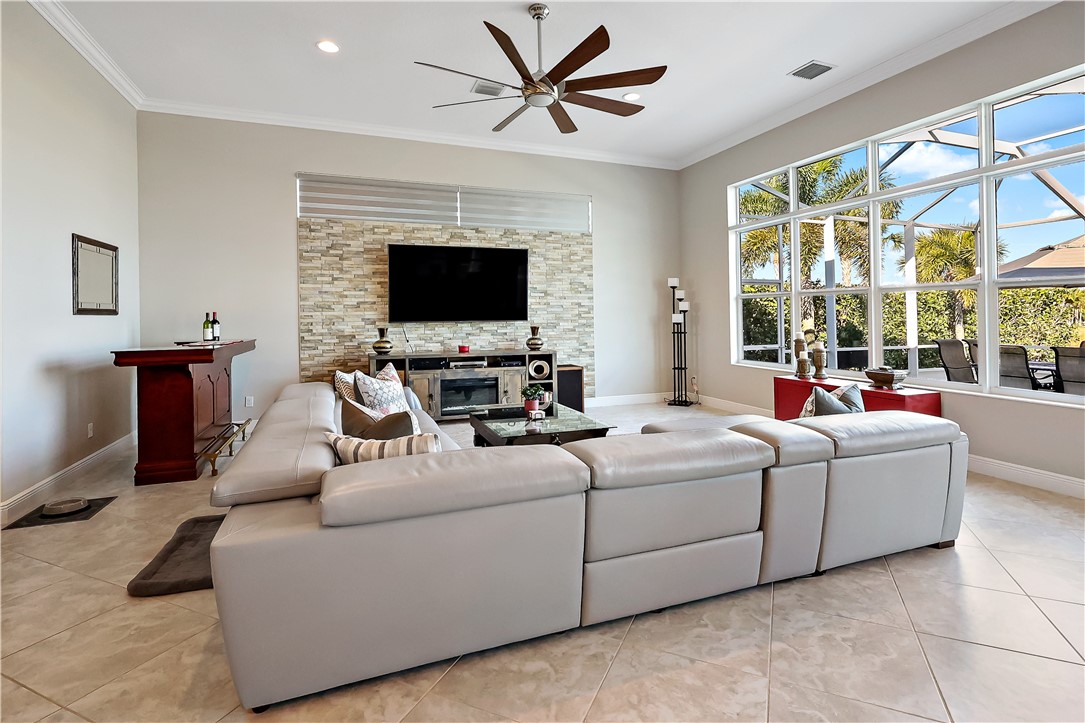 607 Yearling Trail Sebastian, FL 32958 - Photo 21 of 33 a living room with furniture a flat screen tv and a large window