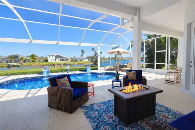 a swimming pool with outdoor seating