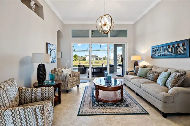 a living room with furniture a rug and a chandelier