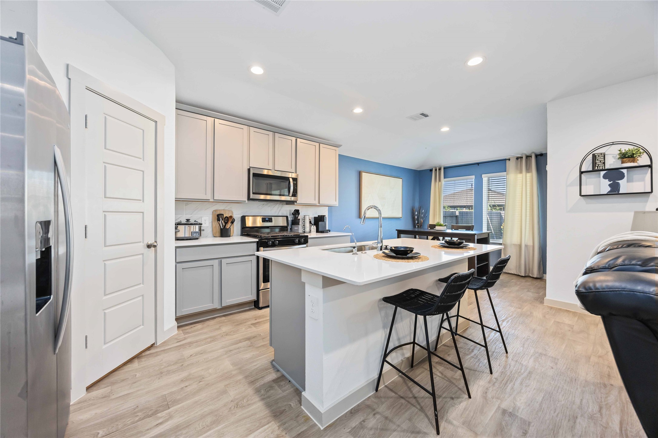 7826 Cattleman Vly Drive Rosharon, TX 77583 - Photo 9 of 29 a kitchen that has a lot of cabinets a sink and a refrigerator