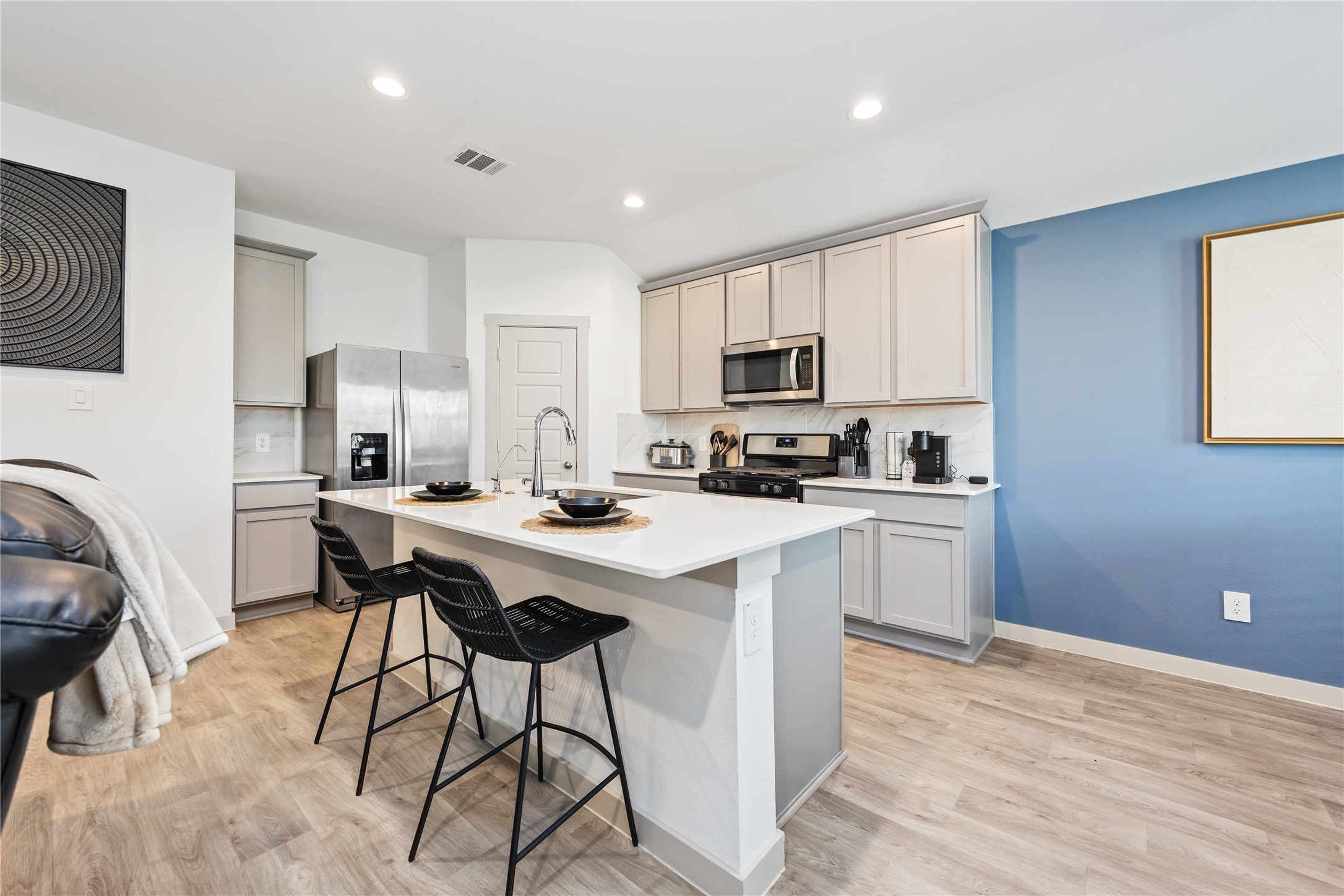 7826 Cattleman Vly Drive Rosharon, TX 77583 - Photo 10 of 29 a kitchen with a sink a stove a refrigerator cabinets and a dining table