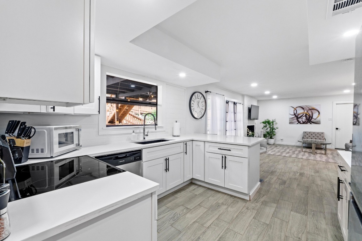 3520 Highland View Drive Austin, TX 78731 - Photo 11 of 38 a kitchen with stainless steel appliances a stove a sink cabinets and a refrigerator