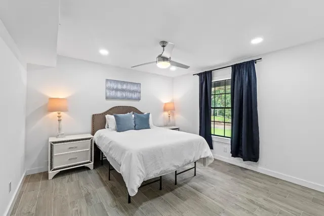 a bedroom with a large bed and a window