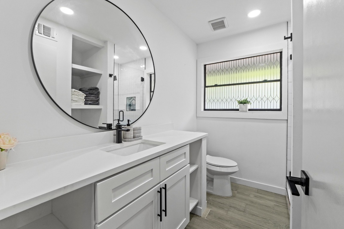 3520 Highland View Drive Austin, TX 78731 - Photo 22 of 38 a view of bathroom with a toilet sink and mirror