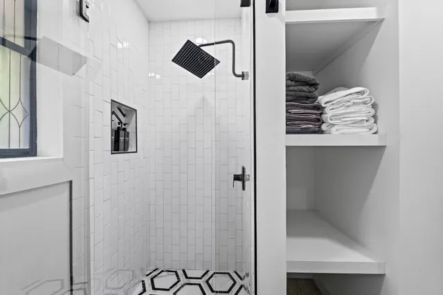 a bathroom with a shower and a sink