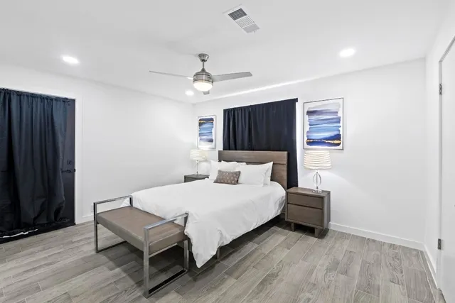 a bedroom with a bed and a night stand