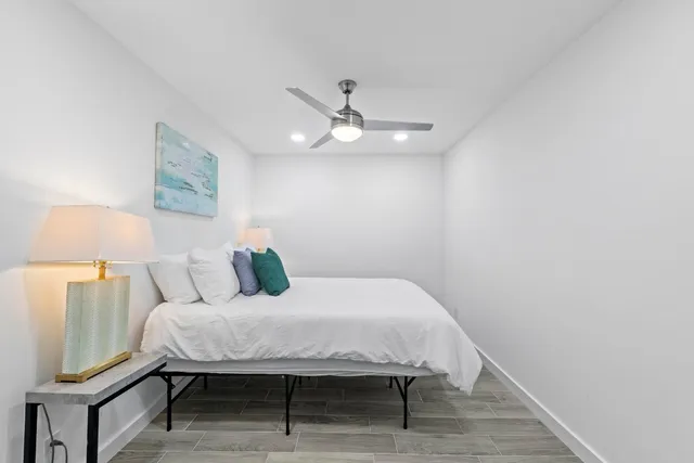 a bedroom with a bed and a lamp