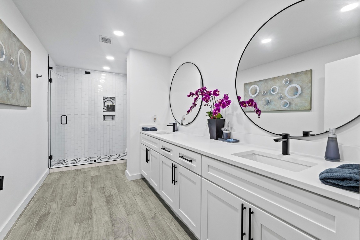 3520 Highland View Drive Austin, TX 78731 - Photo 27 of 38 a bathroom with a double vanity sink mirror and shower