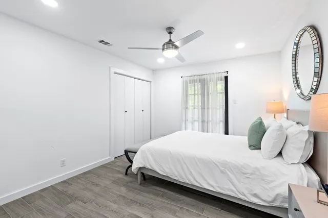 a bedroom with a bed and a mirror