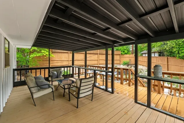 a balcony with wooden floor outdoor seating and city view