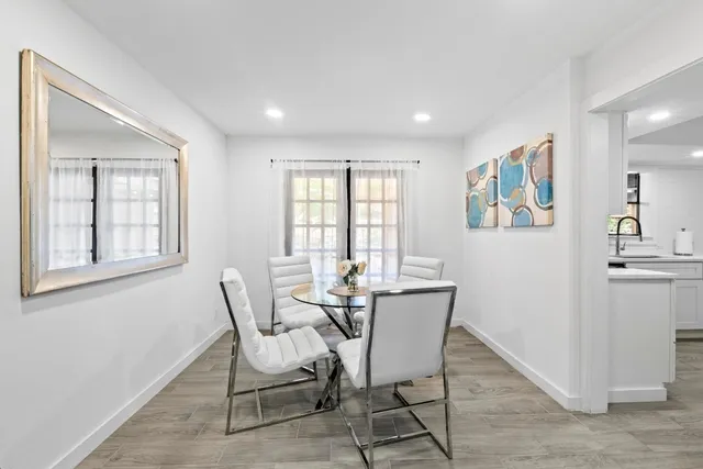 a dining room with furniture and window