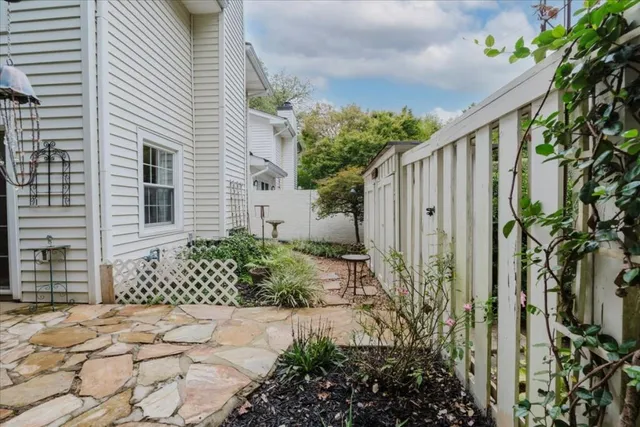 a view of a pathway of house with wooden fence