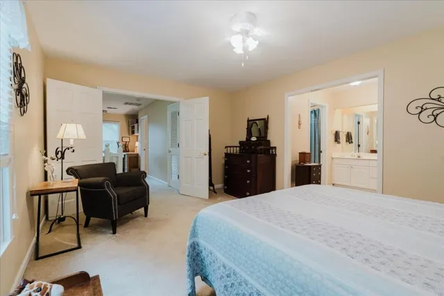 a large bedroom with a bed and furniture