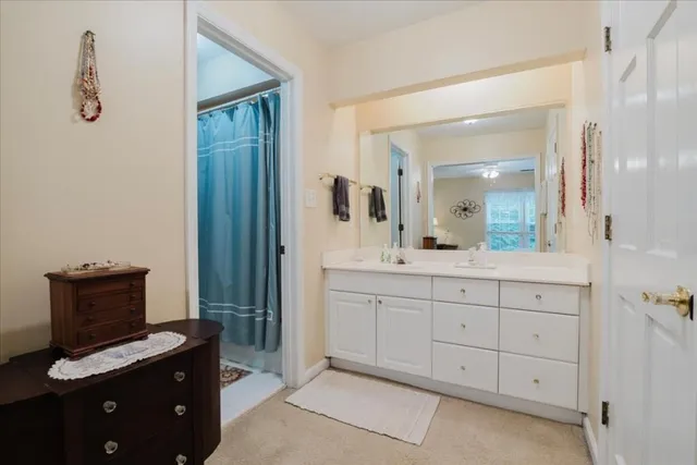 a spacious bathroom with a granite countertop sink mirror and a