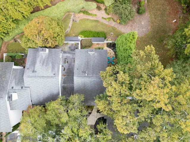 an aerial view of a house with a yard