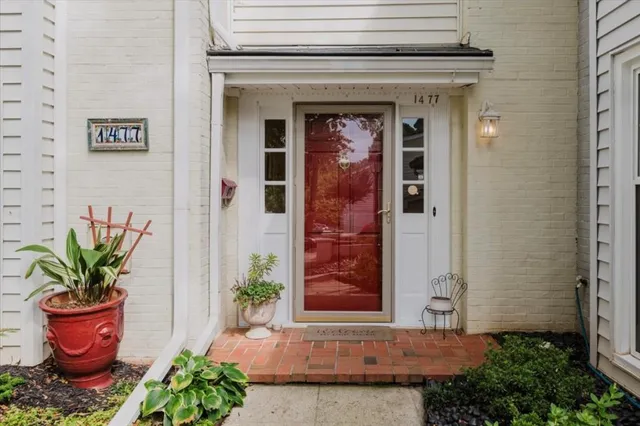 a front view of a house with a potted plant