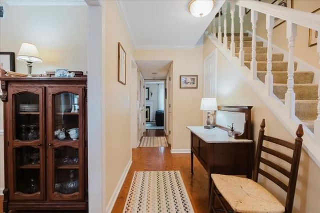a view of a hallway with a livingroom and furniture