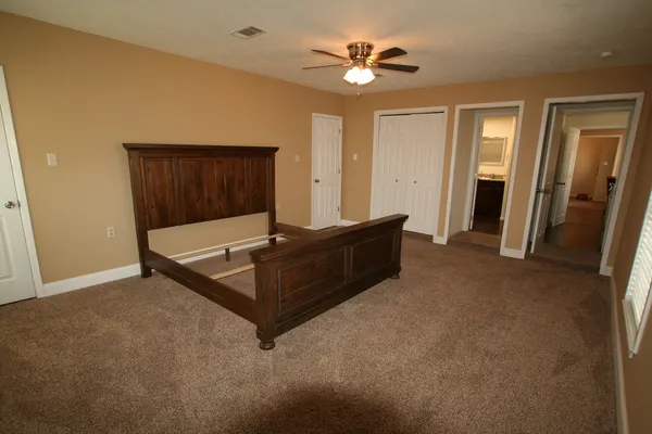 a living room with furniture and a ceiling fan
