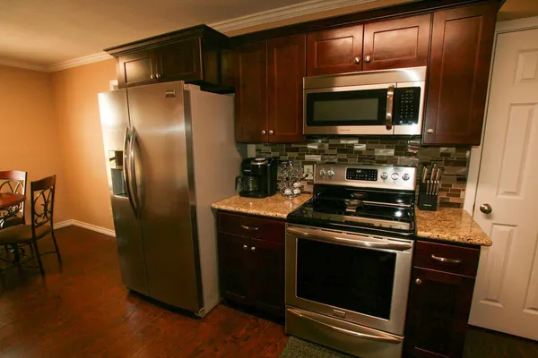 a kitchen with a refrigerator stove and microwave