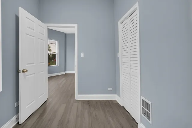 a view of a hallway with wooden floor