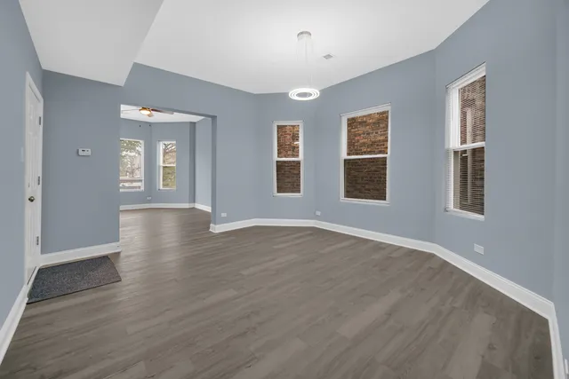 a view of a livingroom with wooden floor and windows