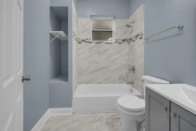 a bathroom with a toilet and a bathtub